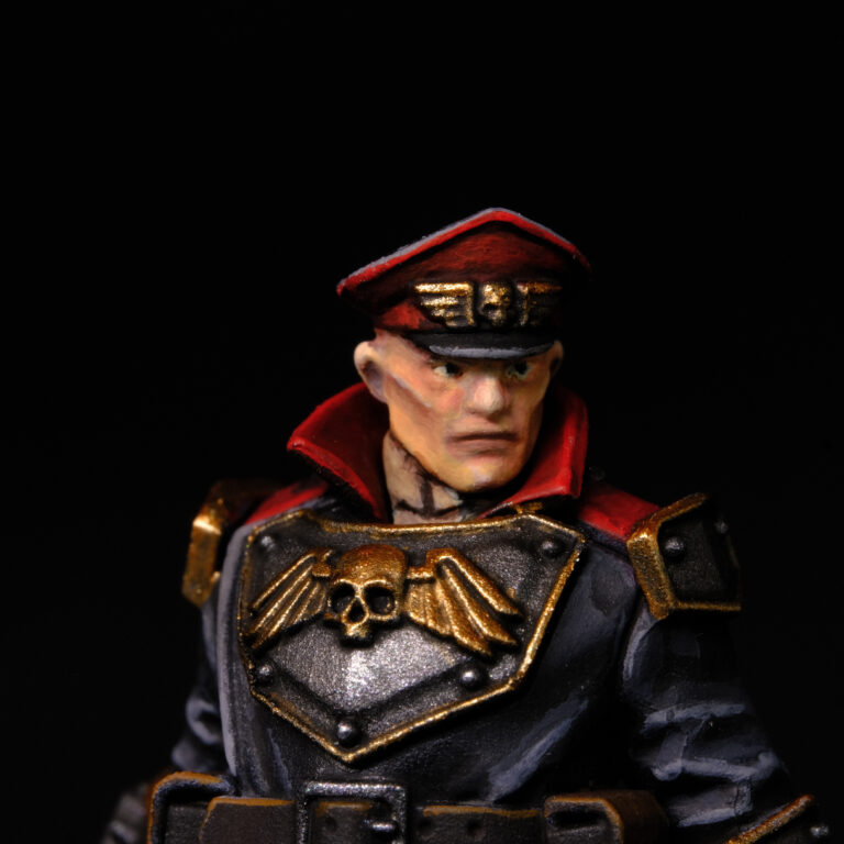 Home Close-up painted Warhammer 40K Astra Militarum Commissar miniature in display quality with detailed grimdark finish.
